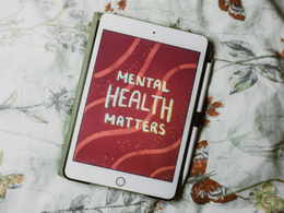 digital tablet with red background and white text reading "mental health matters"
